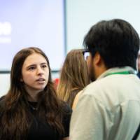 Student talking with event attendee